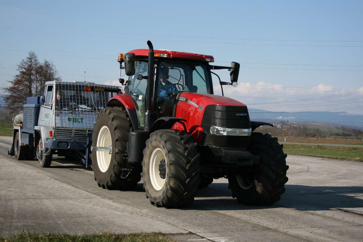 A tractor drives with a brake truck on the test track (Pulling power with a brake truck)
