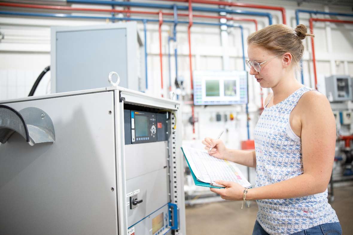 Woman stands in front of a measuring device